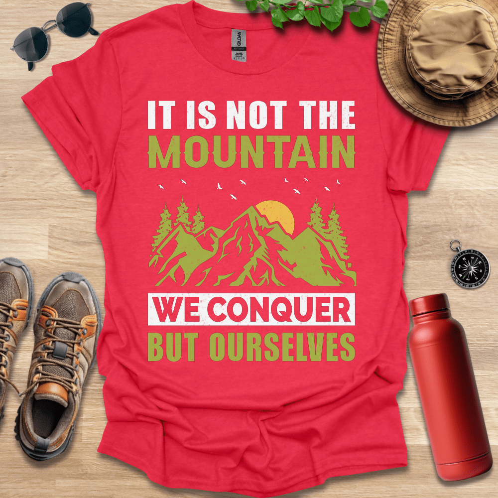 a red shirt that says it is not the mountain we conquer but ourselves