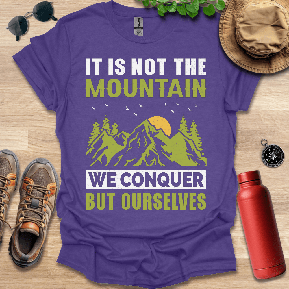 a t - shirt that says it is not the mountain we conquer but ourselves