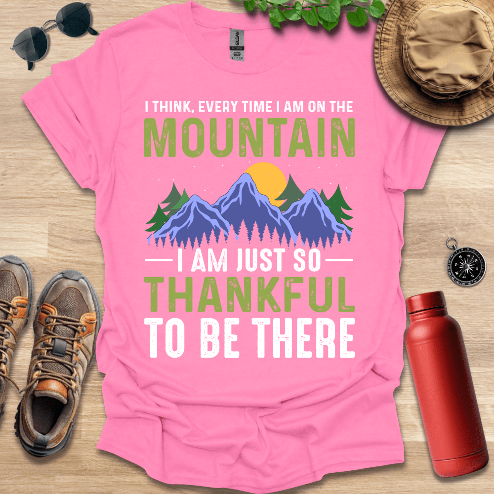 a pink shirt that says i think every time i am on the mountain i am