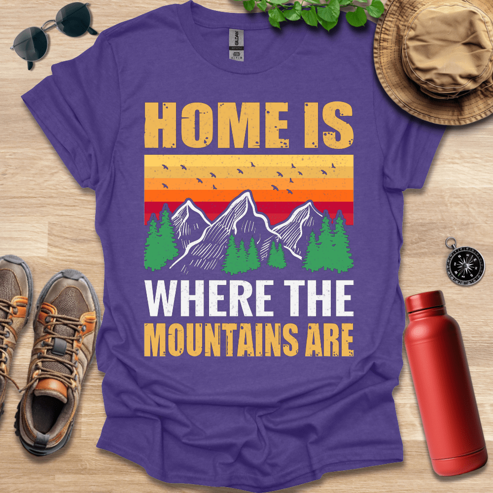 a purple shirt that says home is where the mountains are