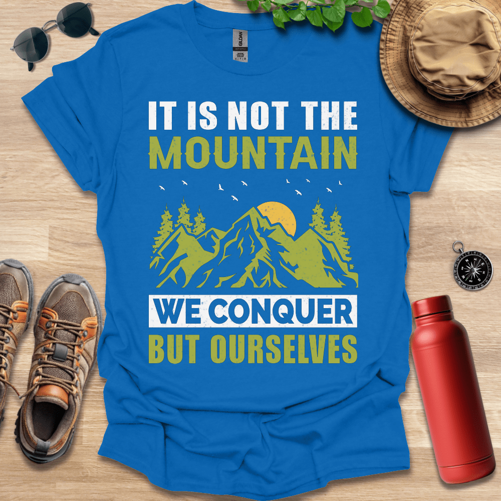 a t - shirt that says it is not the mountain we conquer but ourselves