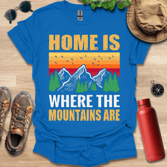 a blue shirt that says home is where the mountains are