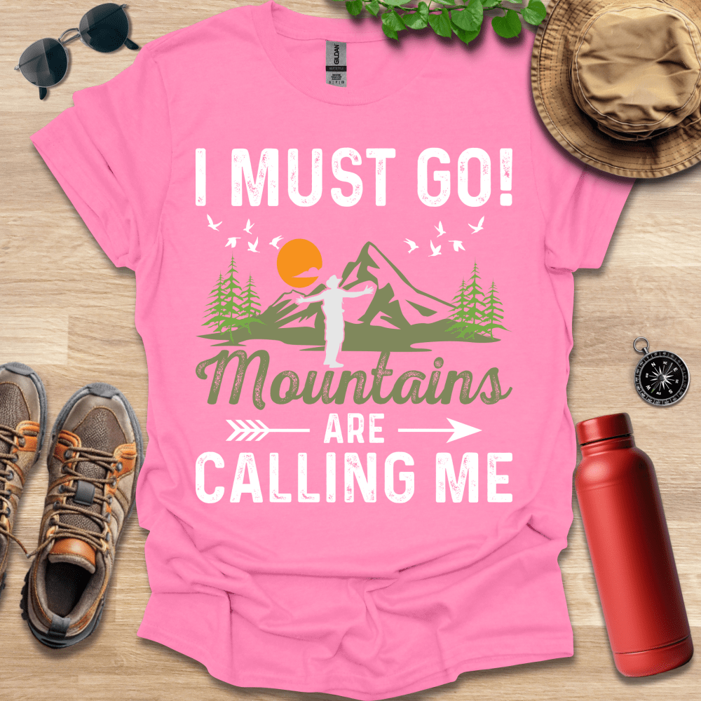 a pink shirt that says i must go mountains are calling me