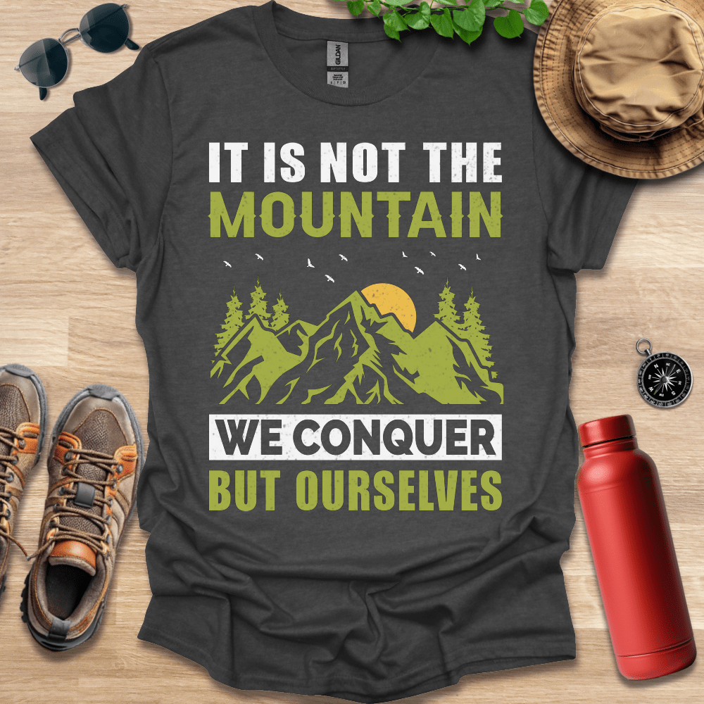 a t - shirt that says it is not the mountain we conquer but ourselves