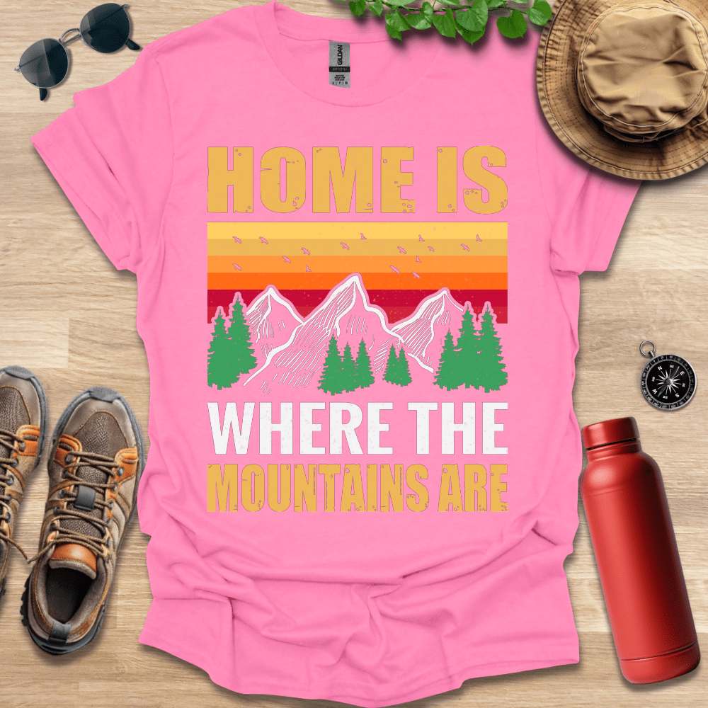 a pink shirt that says home is where the mountains are