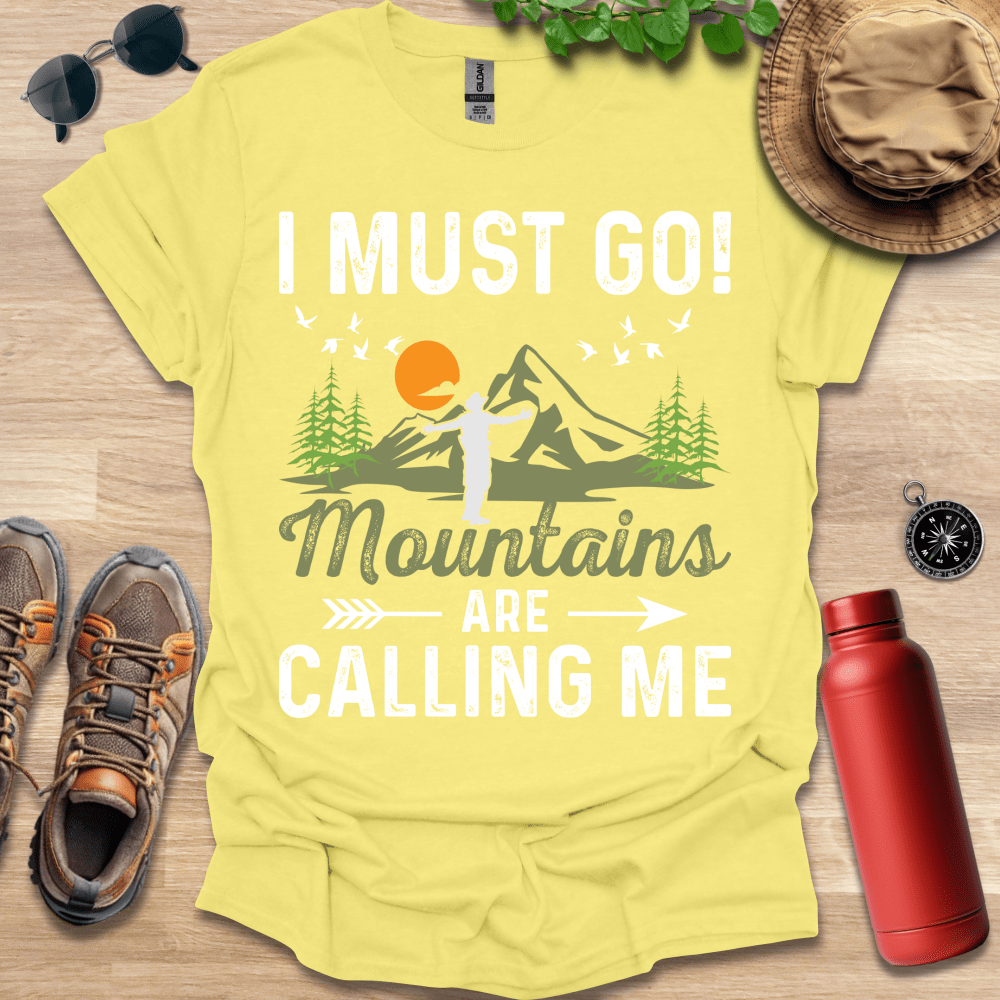 a yellow shirt that says i must go mountains are calling me