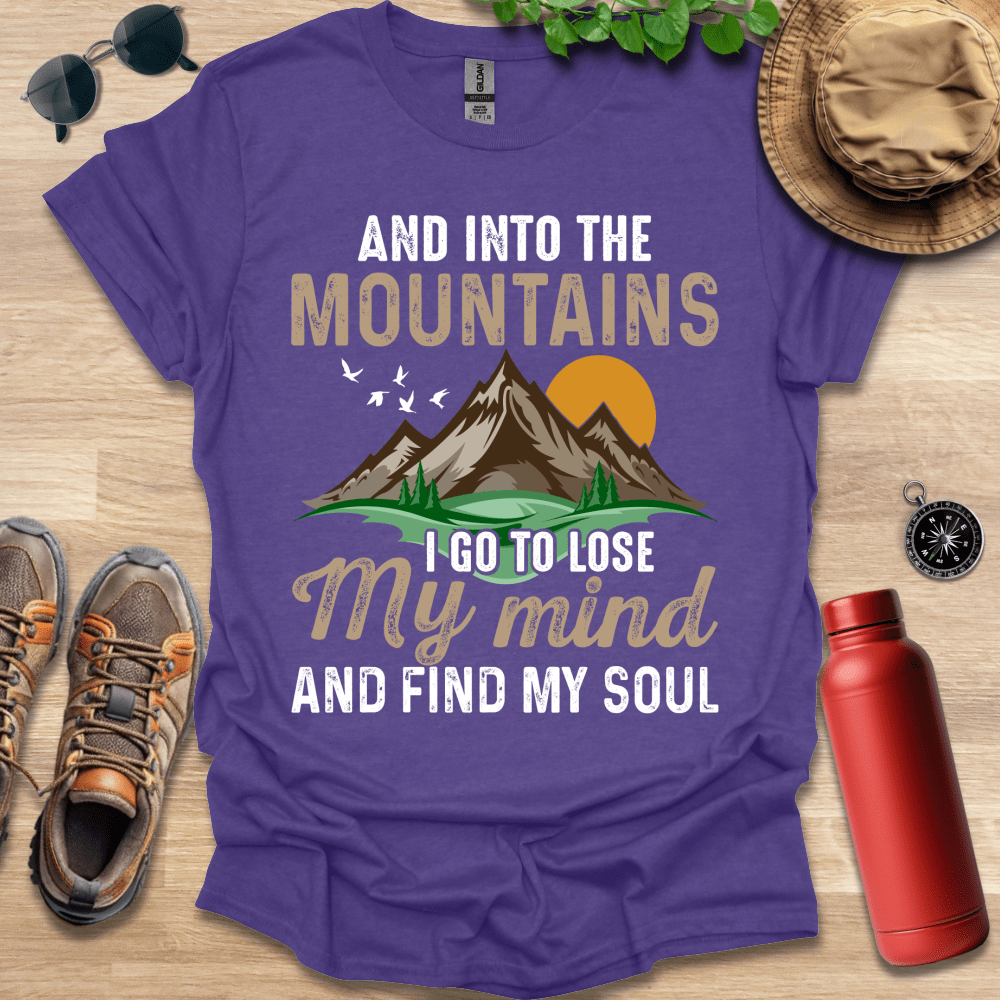 a purple shirt that says and into the mountains i go to lose my mind and