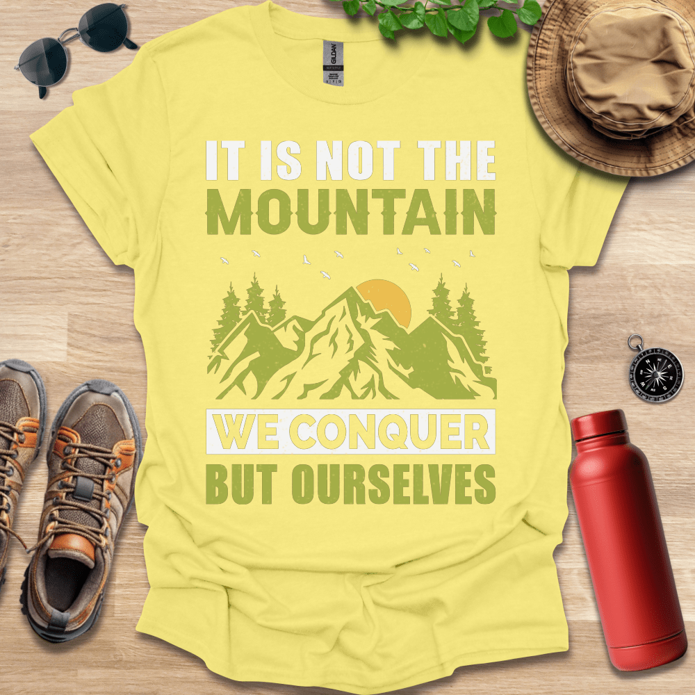 a t - shirt that says it is not the mountain we conquer but ourselves