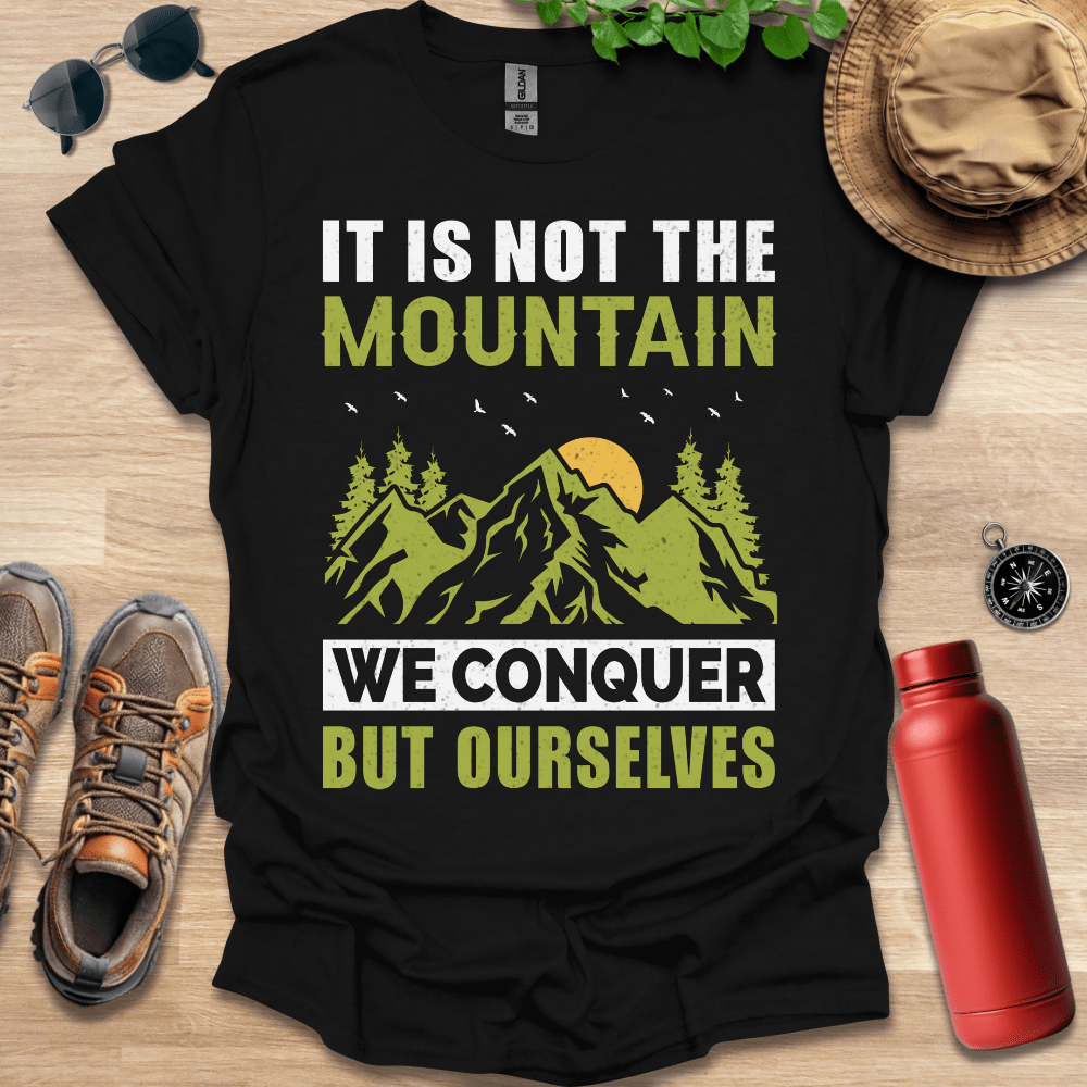 a shirt that says it is not the mountain we conquer but ourselves